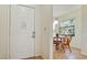 View of the dining area through the front door with a small table and wicker chairs at 4655 46Th Street Ct # 101, Bradenton, FL 34210