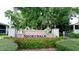Community entrance sign with stone pillars and colorful flowerbeds at 4655 46Th Street Ct # 101, Bradenton, FL 34210
