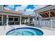 Community hot tub with a nearby covered seating area and spa rules sign at 4655 46Th Street Ct # 101, Bradenton, FL 34210