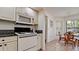 Well-appointed kitchen with a microwave and a stove-oven combination and a pass-through to the breakfast nook at 4655 46Th Street Ct # 101, Bradenton, FL 34210