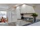 Functional kitchen with granite countertops and white cabinets, offering a view into the dining area at 4655 46Th Street Ct # 101, Bradenton, FL 34210