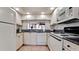 Bright kitchen with white appliances, granite countertops, and ample cabinetry for storage and food preparation at 4655 46Th Street Ct # 101, Bradenton, FL 34210