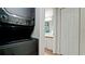 The laundry area features a stacked washer and dryer with a nearby bathroom at 4655 46Th Street Ct # 101, Bradenton, FL 34210