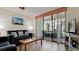 Comfortable living room showcasing a plush sofa, a glass-top coffee table, and access to a screened patio at 4655 46Th Street Ct # 101, Bradenton, FL 34210
