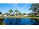 Scenic view of a community pond surrounded by lush greenery and mature trees at 4655 46Th Street Ct # 101, Bradenton, FL 34210