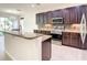 Modern kitchen with granite countertops and dark wood cabinets at 8809 49Th E Ave, Palmetto, FL 34221