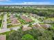 Aerial view of a residential neighborhood with houses and lush green trees at 8809 49Th E Ave, Palmetto, FL 34221