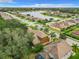 Aerial view of a residential neighborhood with houses, streets, and a lake at 8809 49Th E Ave, Palmetto, FL 34221