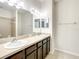 Double vanity bathroom with dark brown cabinets and a large mirror at 8809 49Th E Ave, Palmetto, FL 34221