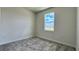 Simple bedroom with neutral walls, gray carpeting and window with a view at 9137 Gulf Haven Dr, Parrish, FL 34219