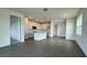 Open concept living space with gray tile floors, white kitchen, and access to other rooms at 9137 Gulf Haven Dr, Parrish, FL 34219