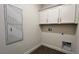 Bright laundry room with white cabinets and tile floor at 9137 Gulf Haven Dr, Parrish, FL 34219