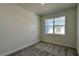 Well-lit bedroom with gray carpet and window overlooking the neighborhood at 9137 Gulf Haven Dr, Parrish, FL 34219