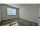 Spacious bedroom with a large window and plush carpeting at 9141 Gulf Haven Dr, Parrish, FL 34219