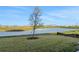 Landscaped backyard with pond view at 9136 Gulf Haven Dr, Parrish, FL 34219