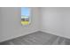 Spacious bedroom with gray carpet and a large window at 9136 Gulf Haven Dr, Parrish, FL 34219