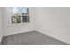Bright bedroom with gray carpet and a large window at 9136 Gulf Haven Dr, Parrish, FL 34219