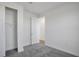 Bright bedroom featuring gray carpet, closet, and an open door at 9136 Gulf Haven Dr, Parrish, FL 34219