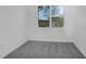 Bright bedroom with gray carpet and a large window at 9136 Gulf Haven Dr, Parrish, FL 34219