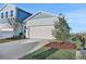 Light blue two-story house with a white garage door and landscaping at 9136 Gulf Haven Dr, Parrish, FL 34219