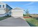Light blue two-story house with a white garage door and landscaping at 9136 Gulf Haven Dr, Parrish, FL 34219