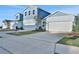 Row of light blue houses with white garage doors and landscaping at 9136 Gulf Haven Dr, Parrish, FL 34219