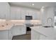 Modern kitchen featuring white cabinets, quartz countertops, and stainless steel appliances at 9136 Gulf Haven Dr, Parrish, FL 34219