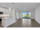 Modern kitchen with white cabinets, quartz countertops, and stainless steel appliances at 9136 Gulf Haven Dr, Parrish, FL 34219