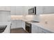 Modern kitchen with white cabinets, quartz countertops, and stainless steel appliances at 9136 Gulf Haven Dr, Parrish, FL 34219