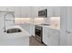 Modern kitchen with white cabinets, quartz countertops, and stainless steel appliances at 9136 Gulf Haven Dr, Parrish, FL 34219