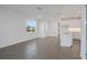 Bright living room with grey tile floors and sliding glass doors leading to the outdoors at 9136 Gulf Haven Dr, Parrish, FL 34219