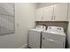 Laundry room with washer, dryer and white cabinets at 9105 Gulf Haven Dr, Parrish, FL 34219