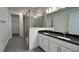 Double vanity bathroom with a large walk-in shower and dark countertops at 9105 Gulf Haven Dr, Parrish, FL 34219