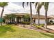 Single-story house with a landscaped yard and palm trees at 254 Rotonda E Blvd, Rotonda West, FL 33947