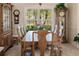 Formal dining room with wood table and chairs and plantation shutters at 254 Rotonda E Blvd, Rotonda West, FL 33947