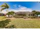 Landscaped backyard with pool and screened enclosure at 254 Rotonda E Blvd, Rotonda West, FL 33947
