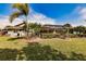 Landscaped backyard with screened enclosure at 254 Rotonda E Blvd, Rotonda West, FL 33947