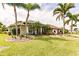 Single-story house with a landscaped yard and palm trees at 254 Rotonda E Blvd, Rotonda West, FL 33947