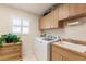 Bright laundry room with built-in cabinets and sink at 254 Rotonda E Blvd, Rotonda West, FL 33947