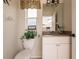 Small bathroom with toilet and vanity at 254 Rotonda E Blvd, Rotonda West, FL 33947
