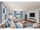 Light and airy living room with light beige sofa and blue accents at 1004 Greenleaf Way, Tarpon Springs, FL 34689