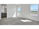 A bright bedroom space with a bathroom en suite features lots of natural light and plush carpeting at 9043 Duany Ln, Lakewood Ranch, FL 34240