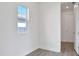 Bright and airy bedroom with a view from the window and an entrance to another room at 9043 Duany Ln, Lakewood Ranch, FL 34240