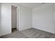 Bedroom with gray carpet, white walls, and doorway to a closet with shelving at 9043 Duany Ln, Lakewood Ranch, FL 34240