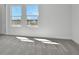 Bright bedroom with carpet, two windows, and views of the neighborhood at 9043 Duany Ln, Lakewood Ranch, FL 34240