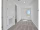 A bright bedroom with a view from the window and an entrance to another room at 9043 Duany Ln, Lakewood Ranch, FL 34240