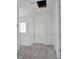 Bright hallway with gray carpet and white trim, including an access panel to the attic at 9043 Duany Ln, Lakewood Ranch, FL 34240