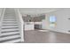 Open-concept kitchen with gray cabinets and stairs to upper level at 9043 Duany Ln, Lakewood Ranch, FL 34240