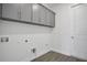 A functional laundry room with ample cabinet space provides efficient organization and streamlined cleaning solutions at 9043 Duany Ln, Lakewood Ranch, FL 34240