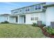 Home's rear elevation, featuring a covered patio and grassy yard at 9144 Gulf Haven Dr, Parrish, FL 34219